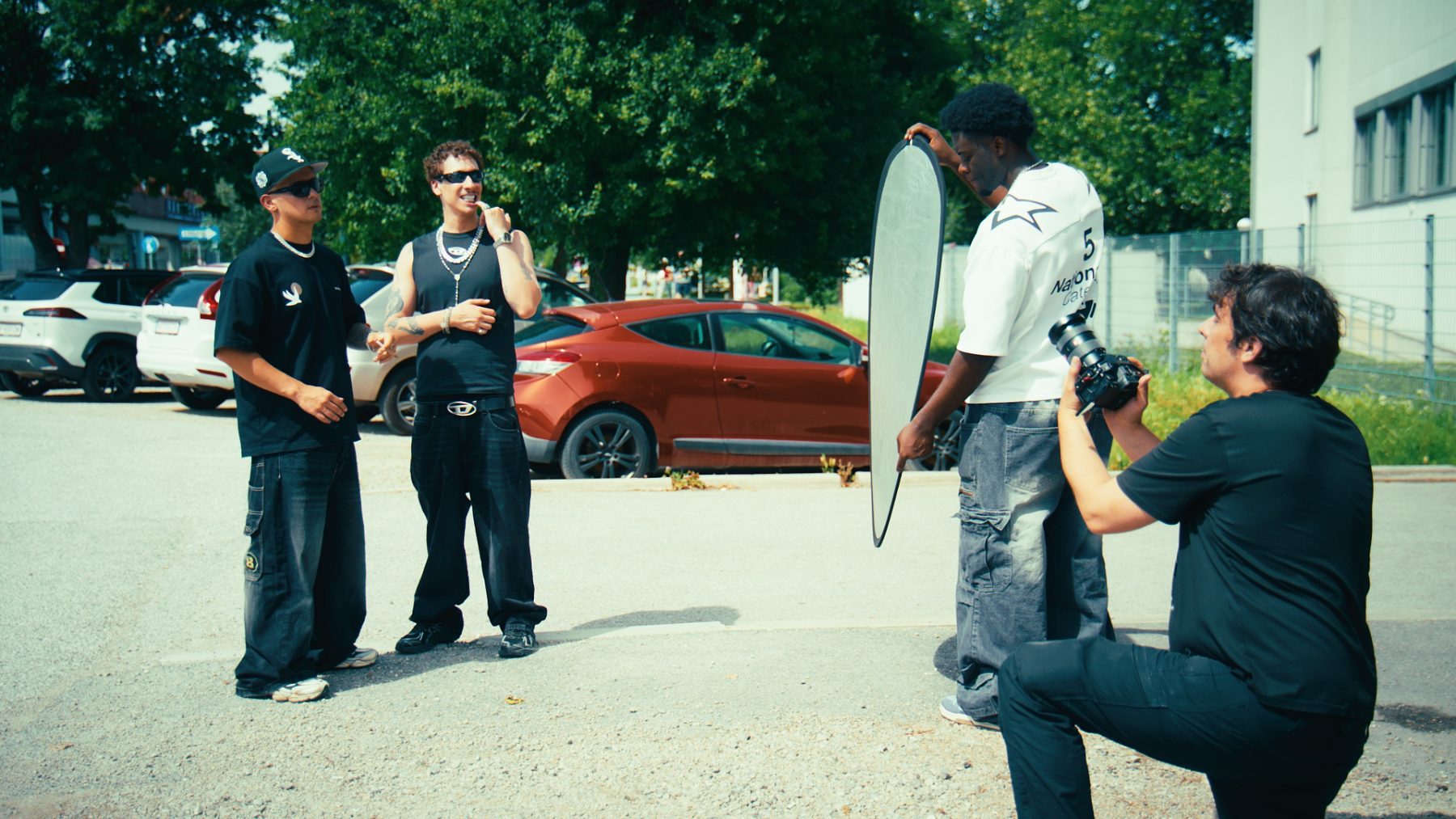 The artists waiting while Isah holds the diffuser and Lenny shoots from a crouch