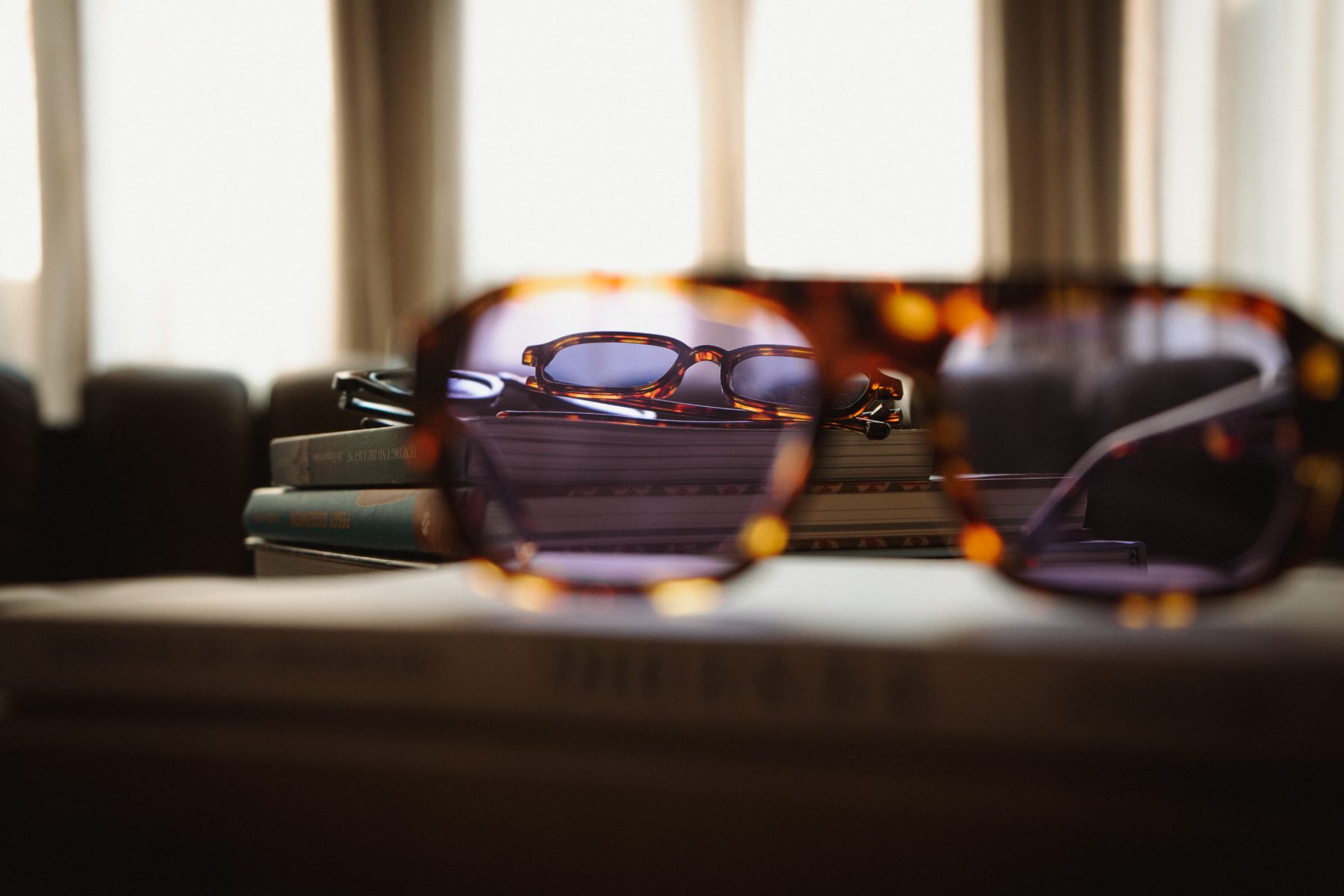 Frames resting on a stack of books in the hotel window light